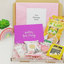 Cargar imagen en el visor de la galería, Mini Pamper Letterbox Gift containing a face mask, tea light candle, hand lotion, tea, and affirmation card.
