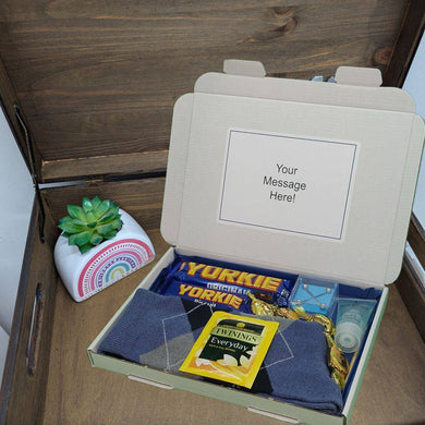 Men's Letterbox Gift Hamper containing chocolates, puzzles, and personal care items.