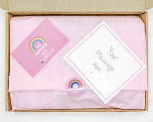 A colourful Children’s Letterbox Gift from The Happiness Box, filled with treats and activities, lined with tissue paper.