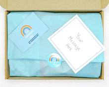 Cargar imagen en el visor de la galería, A colourful Children’s Letterbox Gift from The Happiness Box, filled with treats and activities, lined with tissue paper.
